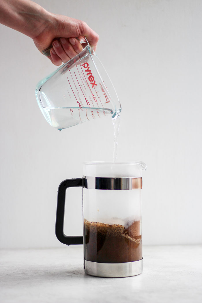 Pouring hot water into a French press 