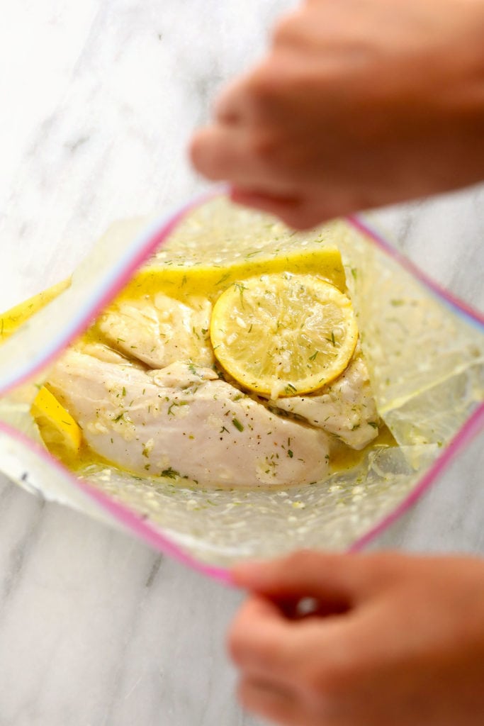 Whip up a batch of this delicious lemon chicken marinade in 5 minutes with 8 simple ingredients -- and no fillers! lemon chicken marinating in a gallon size bag