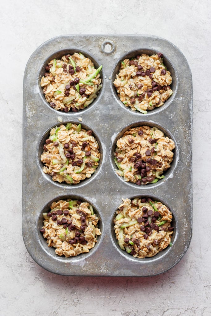 Zucchini oatmeal cups in a muffin tin.