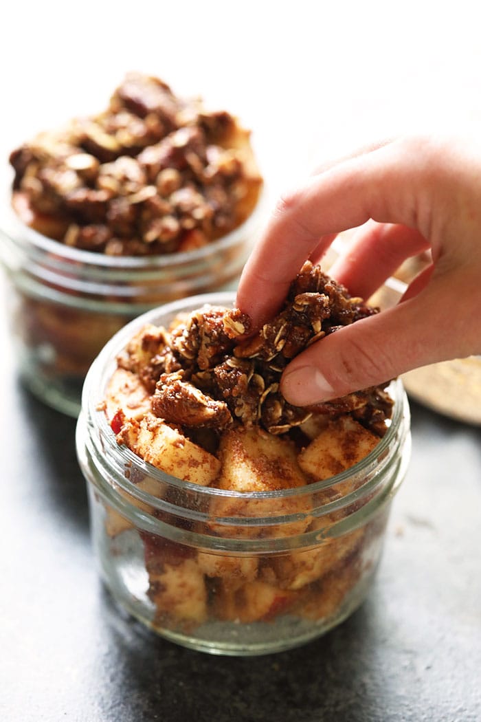 No stove? No problem. This Instant Pot Apple Crisp is made completely in the Instant Pot. All of your favorite fall flavors and spices in one delicious dessert with a drool-worthy crunchy crisp topping. Make this healthy dessert for a treat this week! Instant Pot Apple Crisp with crispy toppings being added