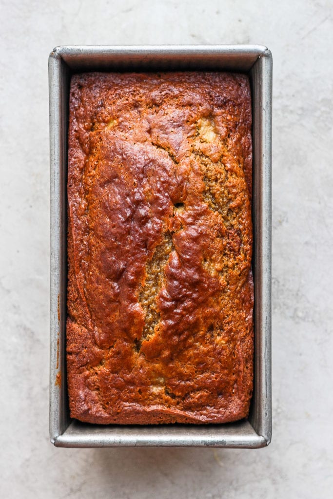 Delicious, airy, moist healthy banana bread coming right up! Our signature healthy banana bread recipe is made with white whole wheat flour, ripe bananas, all-natural sweeteners, and coconut oil. banana bread in loaf pan