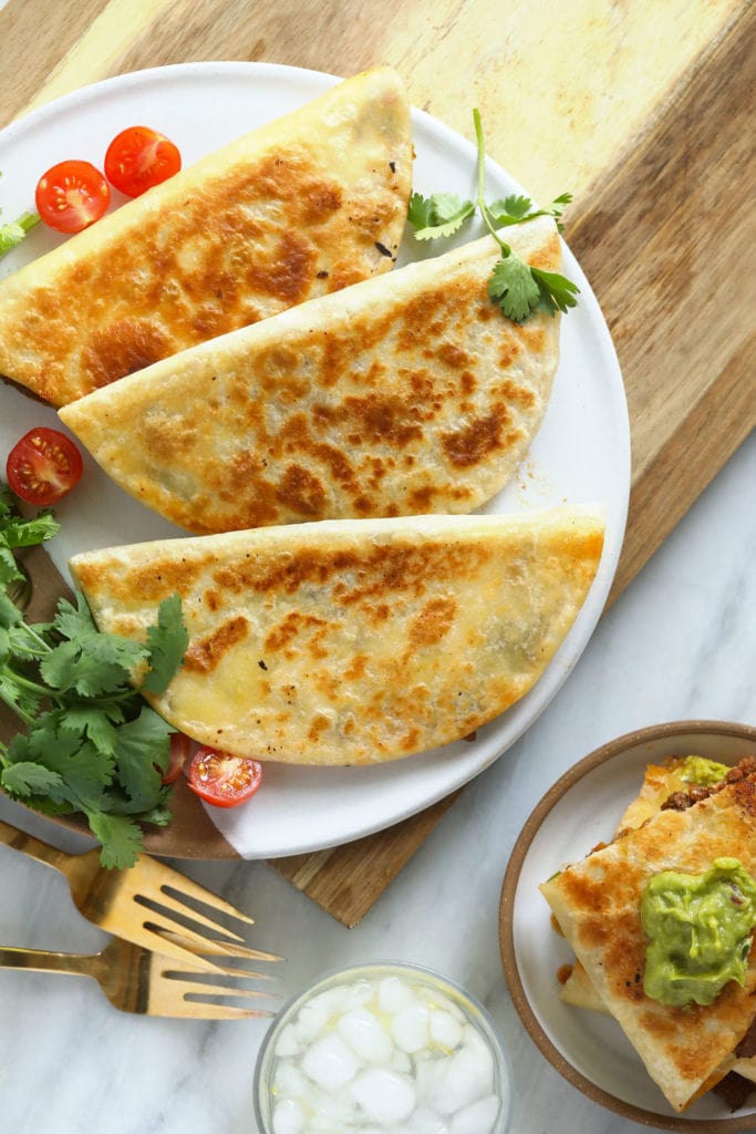 Welcome to the best chicken quesadillas on the internet! This easy weeknight meal comes together in 5 simple steps and under 30 minutes. Enjoy! chicken quesadillas on a plate ready to be served