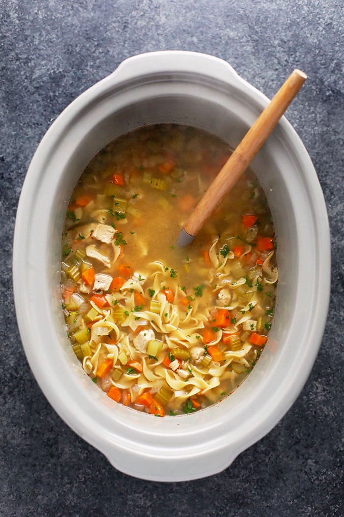 Incredible crockpot chicken noodle soup made with hearty vegetables, chicken breast, broth, and spices! chicken noodle soup crock pot with spoon