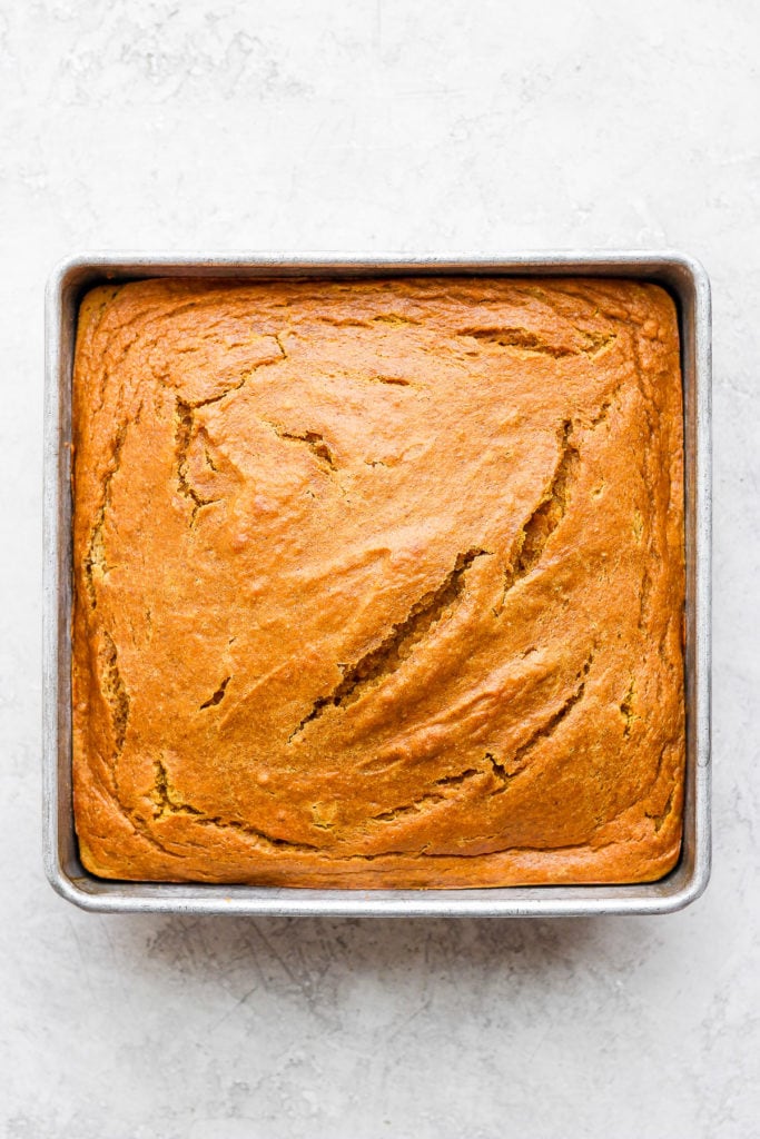 This pumpkin sheet cake is as easy as it is delicious. Packed with simple ingredients and topped with a yummy cream cheese frosting, this dessert can't be beat! pumpkin sheet cake after its come out of the oven from baking