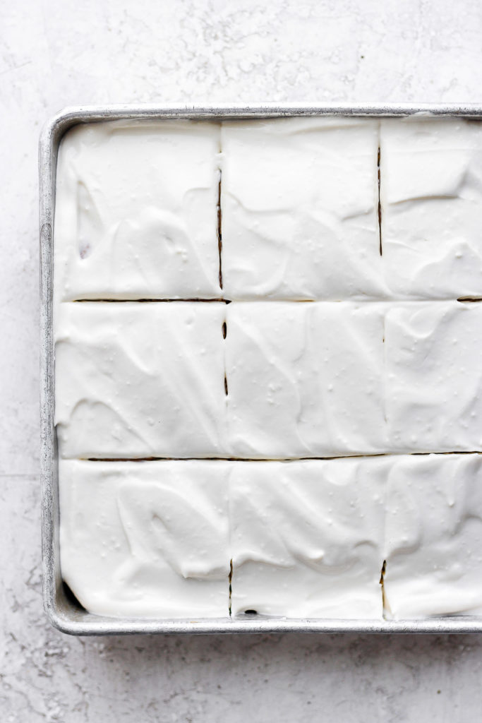 This pumpkin sheet cake is as easy as it is delicious. Packed with simple ingredients and topped with a yummy cream cheese frosting, this dessert can't be beat! pumpkin sheet cake frosted with cream cheese frosting