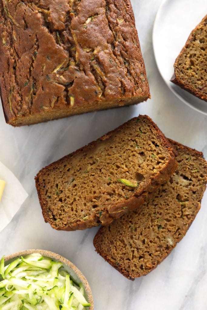 Sliced zucchini bread on a cutting board.