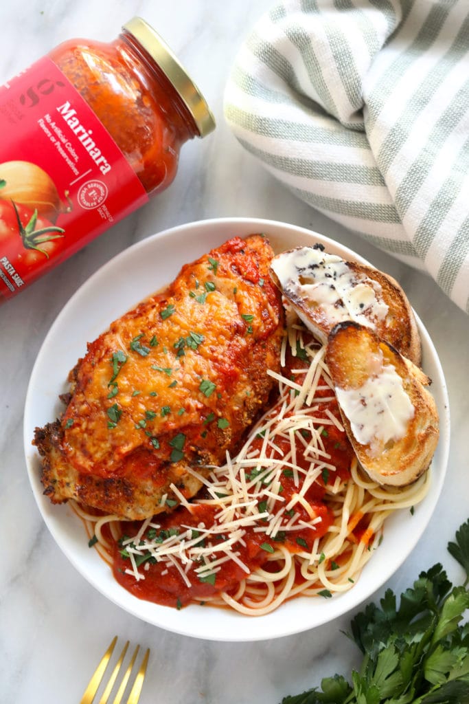 This air fryer chicken parmesan takes no time to whip up and only requires 5 main ingredients. Bonus - there is no oil involved! chicken parm on plate with marinara sauce