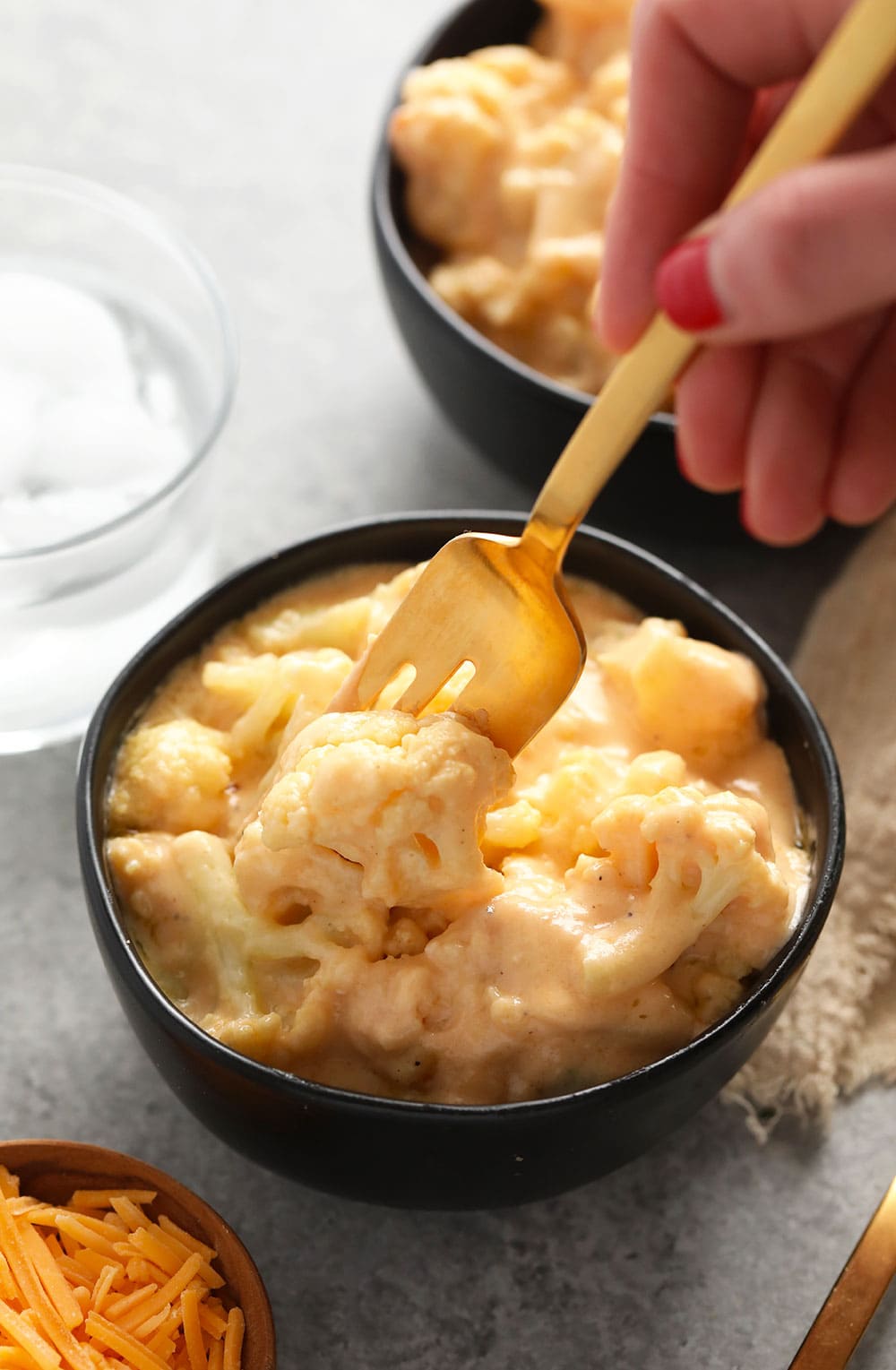 This Three Cheese Cauliflower Mac and Cheese is keto, low carb, and oh so delicious! And did we mention it packs 20g of protein? Yah welcome. cauliflower mac and cheese in a bowl ready to eat