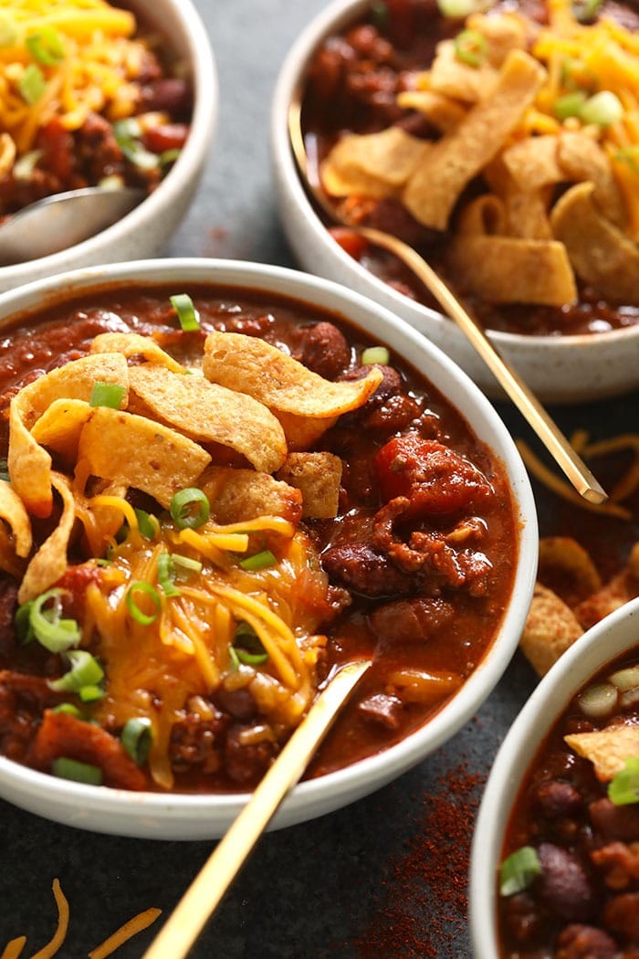 The best chili recipe you'll ever eat is right here! Our classic beef chili is made with ground beef, beans, diced tomatoes, and a homemade chili seasoning. bowl of beef chili with Fritos and shredded cheese