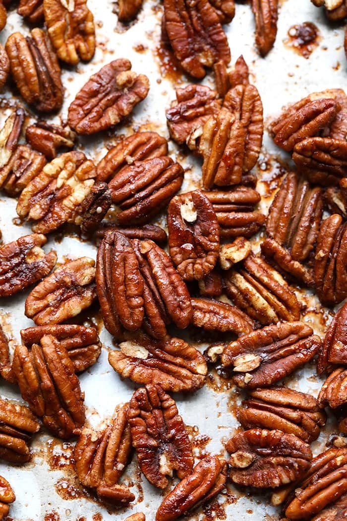 There's nothing better than sweet roasted pecans on a fall salad. Make these Oil-Free Maple Roasted Pecans in 10 minutes! Roasted pecans on baking sheet.