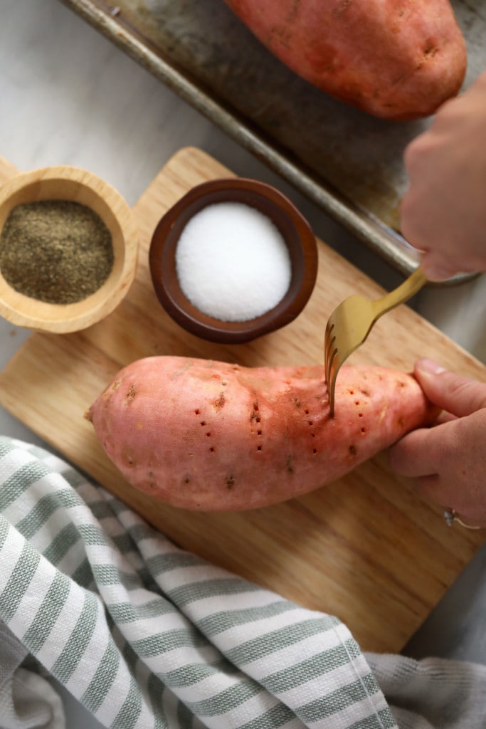 Follow this easy tutorial for How to Bake Sweet Potatoes to get perfectly tender taters every time! poking holes in sweet potato