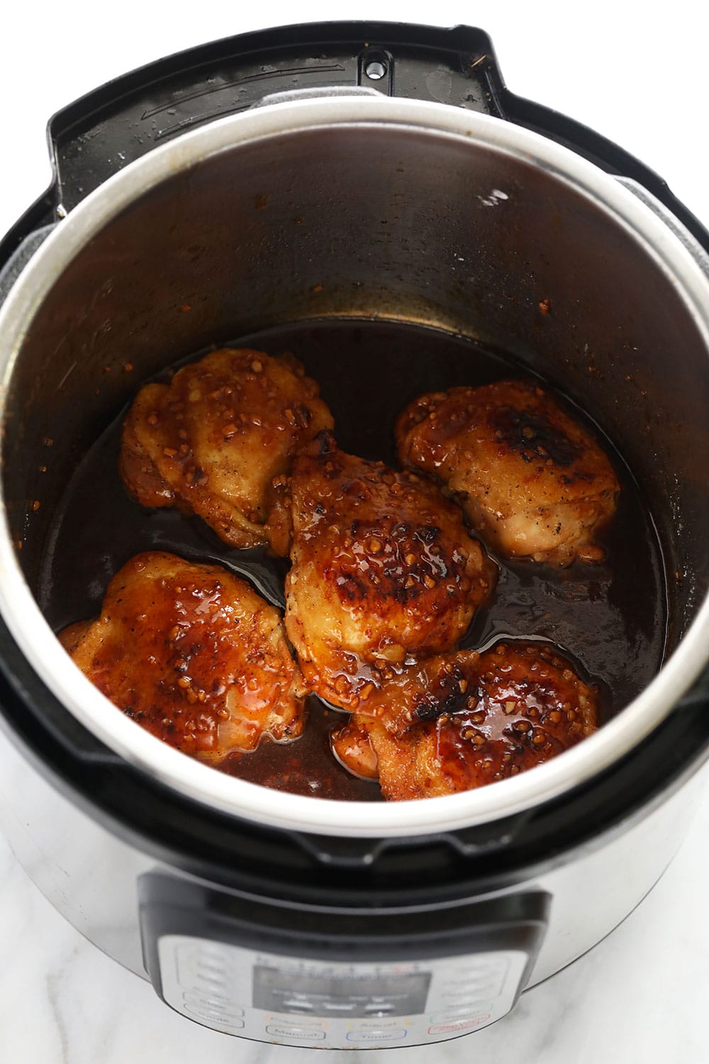 The best honey garlic chicken thighs made in the Instant Pot in under 30 minutes! honey garlic chicken thighs in Instant Pot