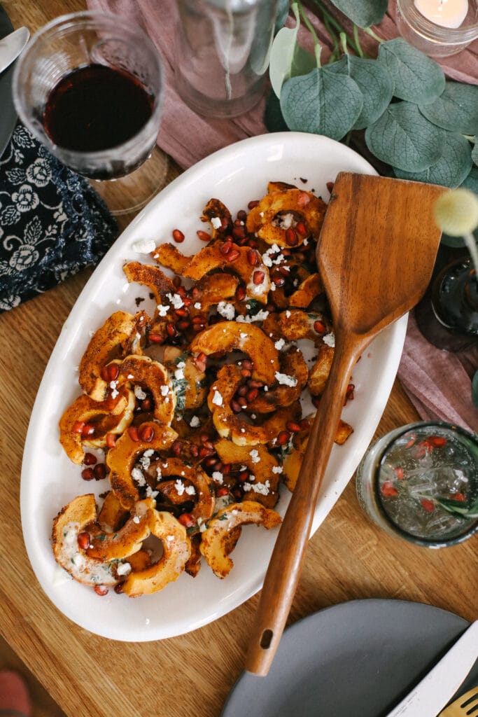 This Easy Roasted Delicata Squash is the perfect pairing to any harvest meal! Enjoy a creme fraiche drizzle with the rich savory flavors of delicata squash. No peeling required! squash on plate