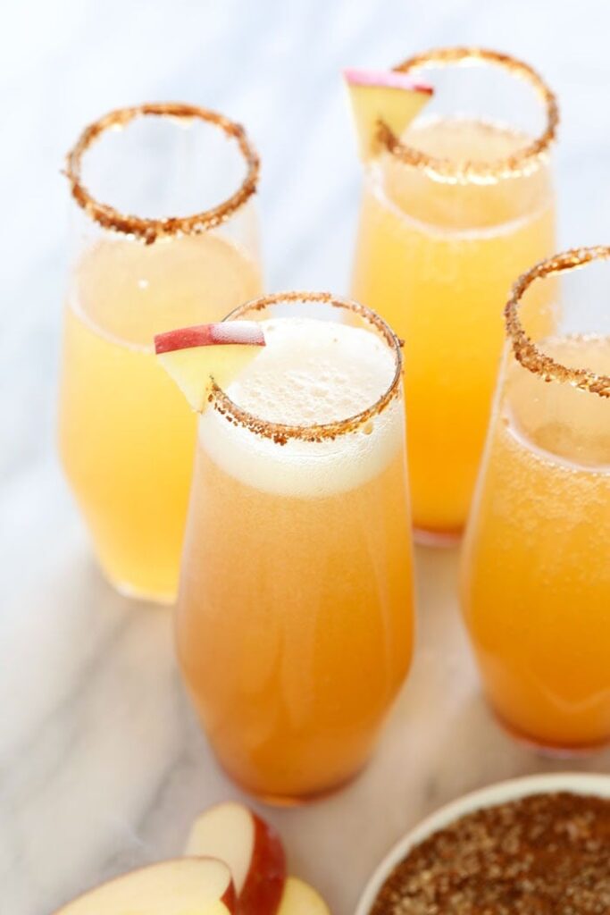 This festive Apple Cider Champagne Cocktail is the perfect combination of sweet, tart and bubbly! Made from just 2 ingredients (apple cider and champagne!), this cocktail is a super easy drink that will leave your guests refreshed and impressed. Cheers! cocktail in champagne flute