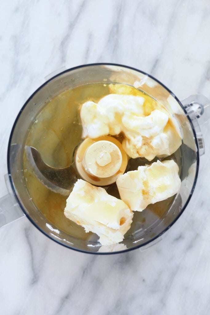All the ingredients for the cream cheese filling in a food processor.