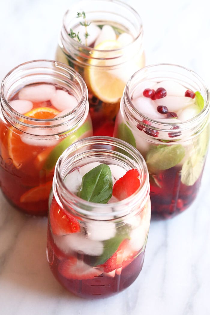 Fruit Infused Water never tasted better! These 4 delicious fruit infused water recipes include pomegranate juice ice cubes for a flavor burst you’ll love. Stay hydrated with these refreshing and easy to make fruit infused waters! infused waters in mason jars