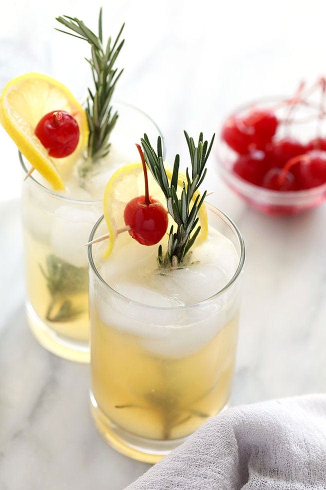This Rosemary Collins Recipe is a twist on the traditional vodka collins, just in time for those holiday parties! Complete with a rosemary simple syrup and fresh lemon juice, this is the perfect refreshing cocktail even in the winter months. vodka collins in glass