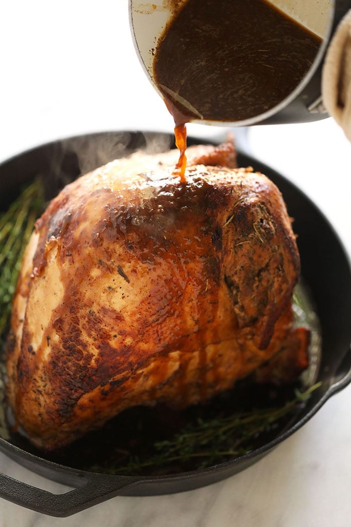 This sous vide turkey is the most tender and delicious turkey you will ever taste! If you're looking for a turkey recipe that you can prepare before Thanksgiving day or friends giving, then this sous vide turkey is for you! Pouring white wine sauce over the turkey