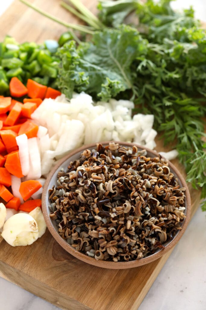 This cozy stovetop Chicken Wild Rice Soup is packed with healthy veggies and made creamy with a delicious roux. Make a large batch and enjoy it throughout the week! ingredients for chicken wild rice soup ready to be mixed together
