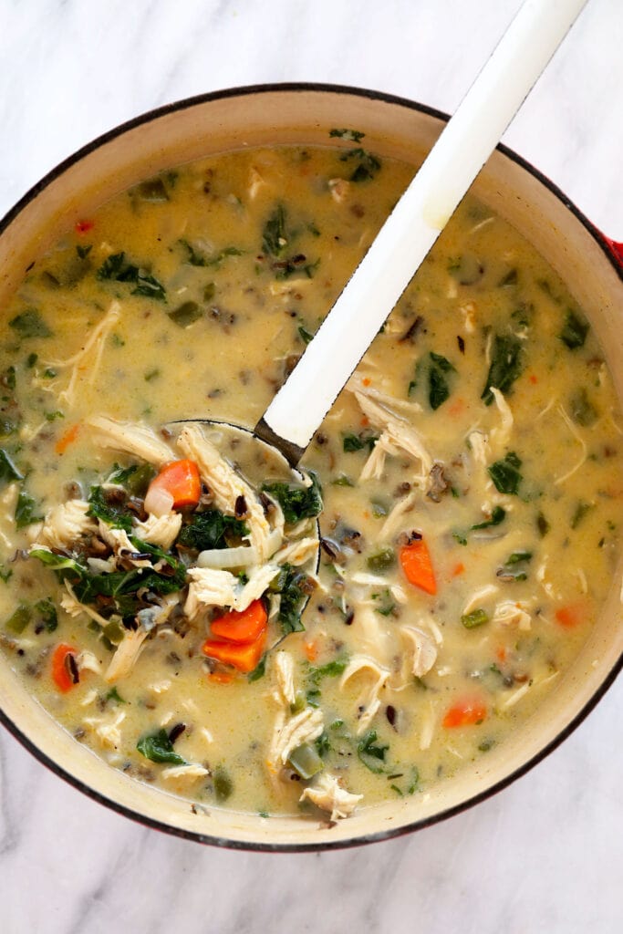 This cozy stovetop Chicken Wild Rice Soup is packed with healthy veggies and made creamy with a delicious roux. Make a large batch and enjoy it throughout the week! chicken wild rice soup in a stock pot