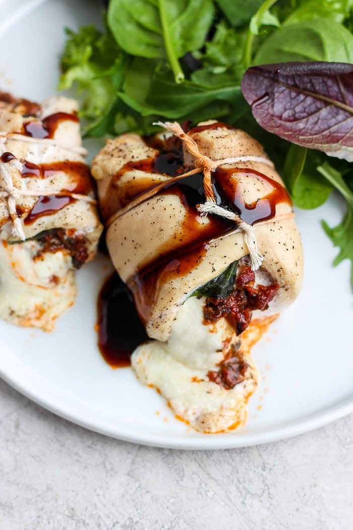 This Caprese Stuffed Chicken Breast Recipe is an easy, healthy dinner that will wow your dinner guests. With only a few ingredients and easy step-by-step instructions, you'll have this delicious dinner ready in under 60 minutes. Enjoy! caprese stuffed chicken breast served on a plate