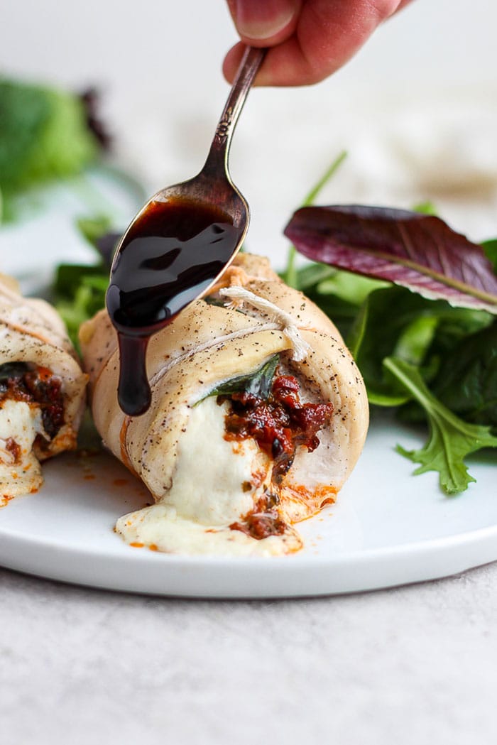 This Caprese Stuffed Chicken Breast Recipe is an easy, healthy dinner that will wow your dinner guests. With only a few ingredients and easy step-by-step instructions, you'll have this delicious dinner ready in under 60 minutes. Enjoy! Caprese stuffed chicken breast drizzled with balsamic glaze.