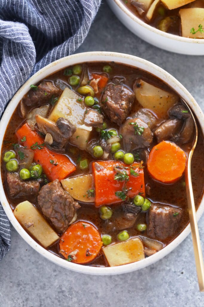 This is the most tender and flavorful Slow Cooker Beef Stew you'll ever have! Fall apart beef and tons of veggies make this beef stew the perfect (and healthy!) cozy comfort meal. slow cooker beef stew in a bowl