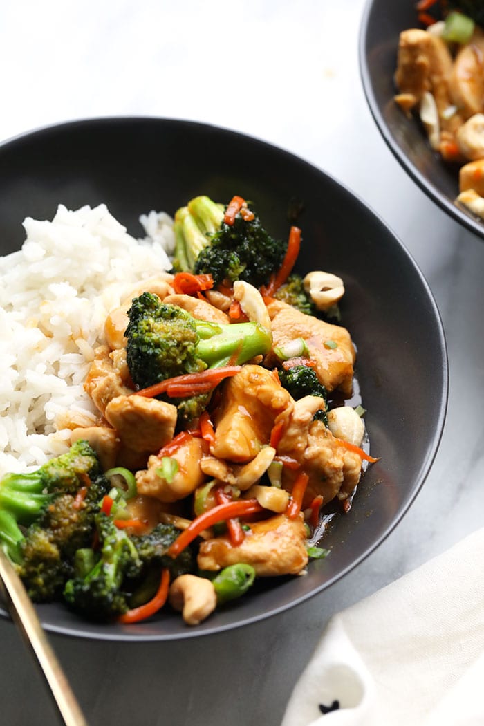Our homemade Chicken Stir Fry is a great alternative to takeout! The sauce is made with fresh ginger, garlic, soy sauce, honey, and a little sriracha. chicken stir fry in bowl