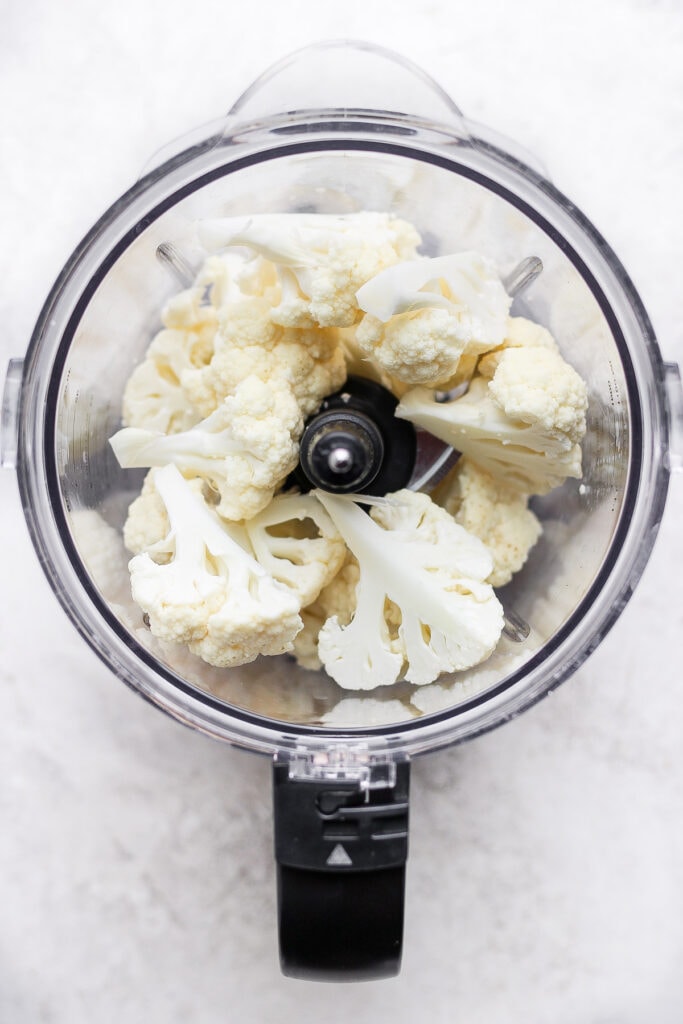 Raw florets of cauliflower in a food processor.