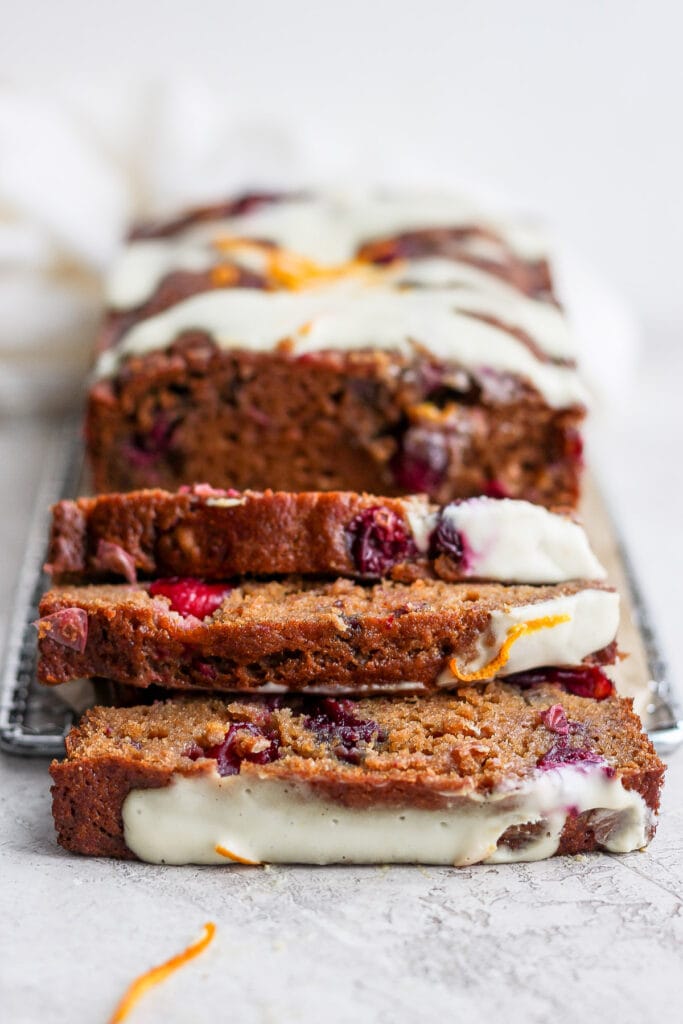This seriously moist Cranberry Orange Bread is flavor-packed with fresh cranberries and orange zest, and finished with a delicious cream cheese glaze. cranberry orange bread slices