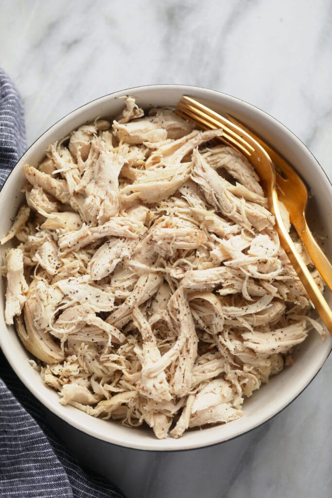 Wondering how to make shredded chicken in the Instant Pot? Look no further! This easy Instant Pot Shredded Chicken recipe is ready in less than 20 minutes, and will easily become a meal-prep staple in your home. instant pot shredded chicken in a bowl