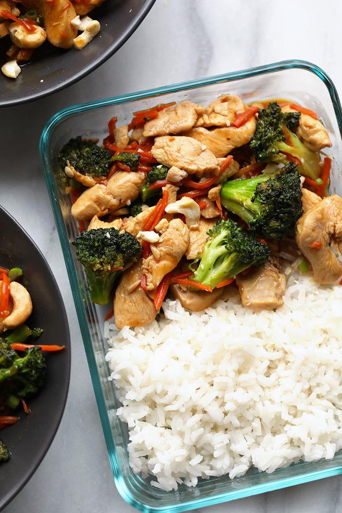 Our homemade Chicken Stir Fry is a great alternative to takeout! The sauce is made with fresh ginger, garlic, soy sauce, honey, and a little sriracha. chicken stir fry in meal prep container