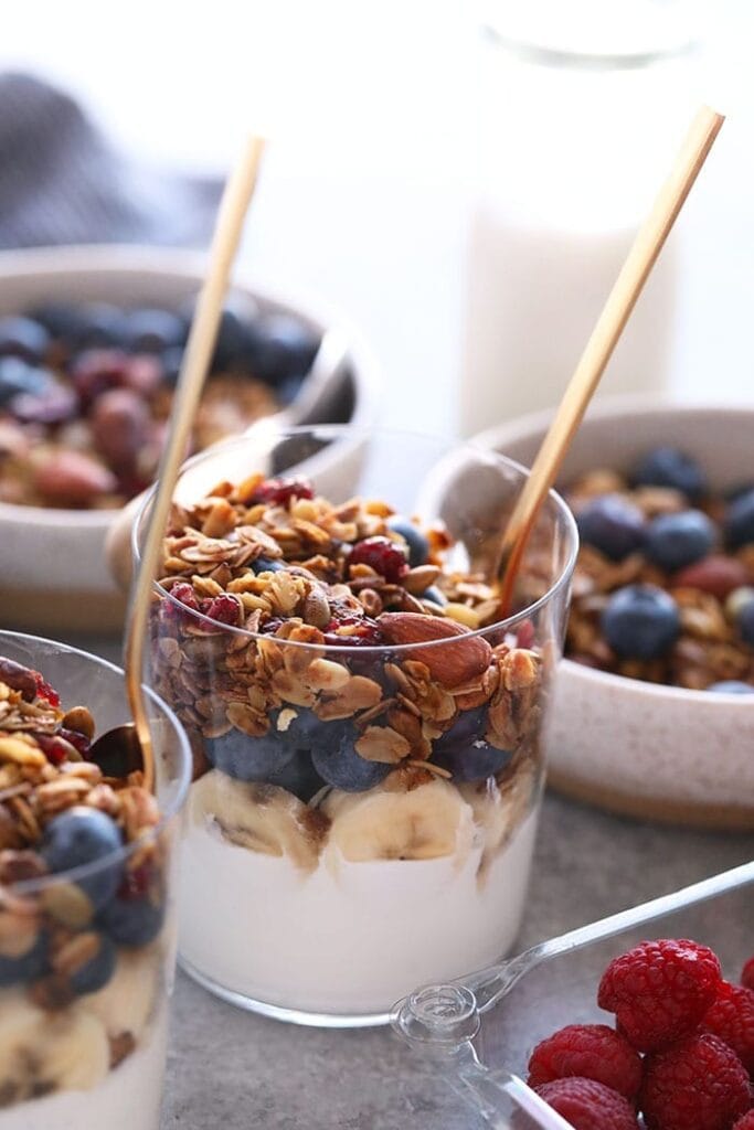 Make a batch of this healthy granola for quick access to a healthy crunch all week long! Store this healthy granola in an airtight container for a healthy breakfast option with a big crunch. granola in cup on yogurt