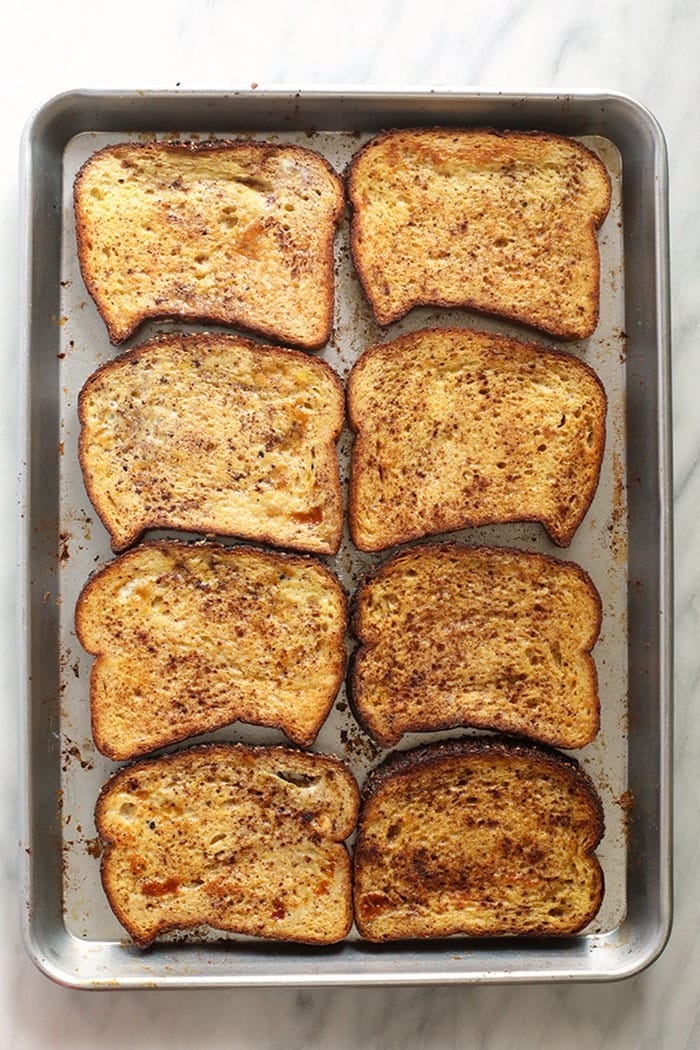 This Sheet Pan French Toast is the answer to your brunch dreams! It's ready to serve in under 30 minutes, and can easily be doubled to serve a crowd. Happy brunching! sheet pan french toast on a baking sheet ready to go in the oven