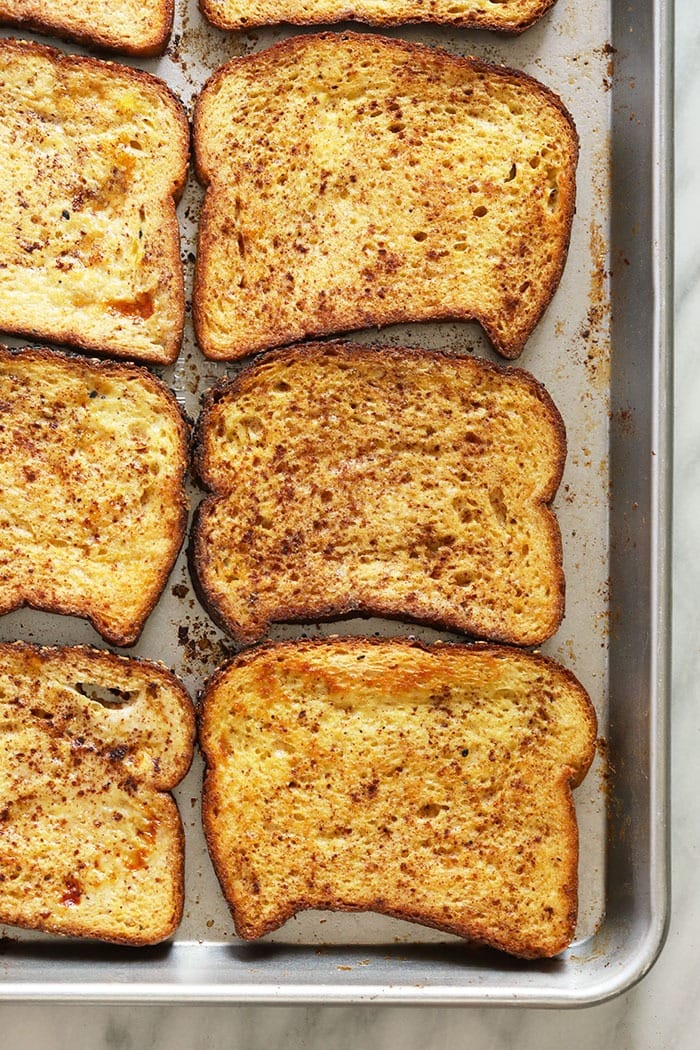 This Sheet Pan French Toast is the answer to your brunch dreams! It's ready to serve in under 30 minutes, and can easily be doubled to serve a crowd. Happy brunching! french toast on a baking sheet