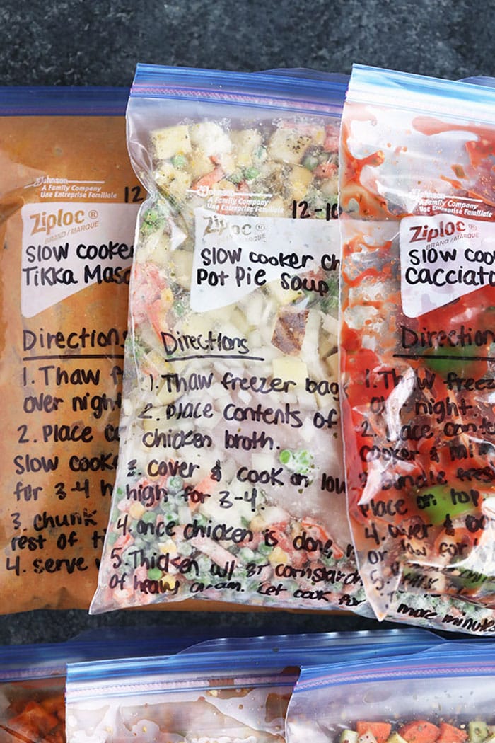 We're sharing 6 Crockpot Freezer Meals with a shopping list and everything you need to know about prepping and cooking these freezer meals. freezer meals in bags on countertop