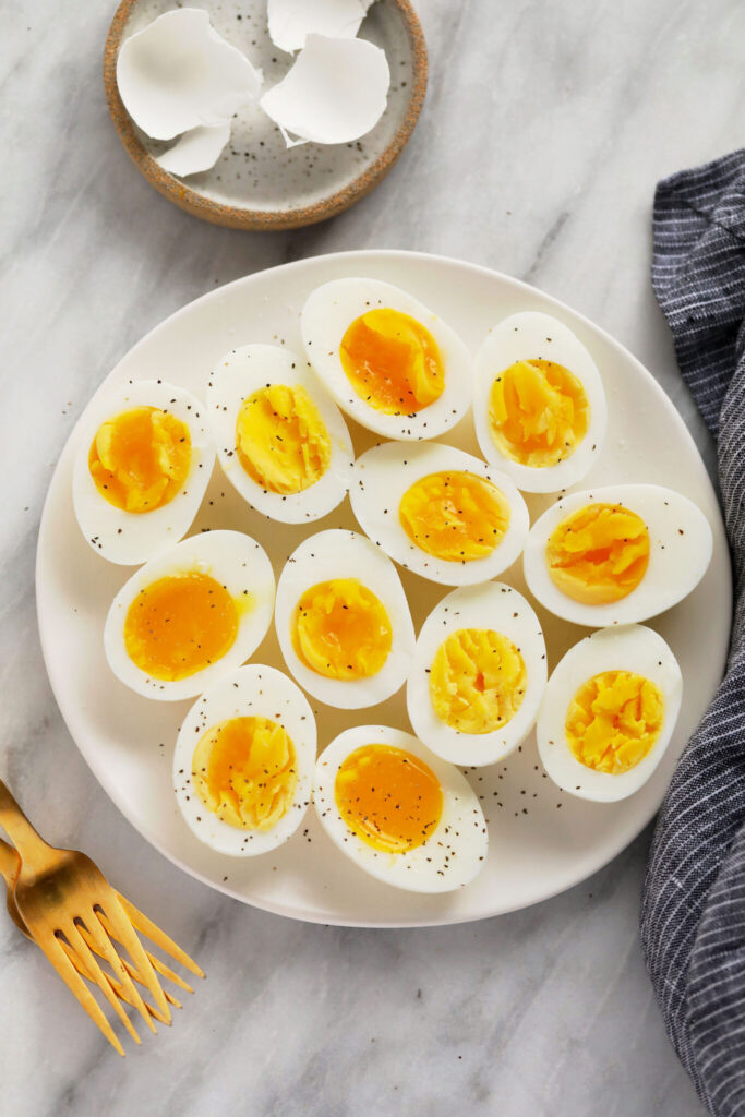 This is the only easy peel hard boiled eggs recipe you'll ever want to use again. In this post, we'll teach you how to hard boil eggs + answer all your questions about cooking hard boiled eggs. hard boiled eggs on plate with forks