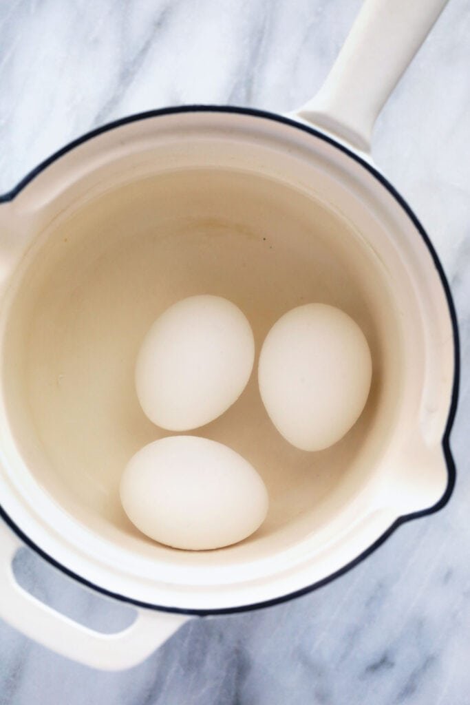 Are you ready to get PERFECT hard boiled eggs every single time? This hard boiled eggs recipe is foolproof and will get you the exact kind of yolk you want! eggs in pot with waer