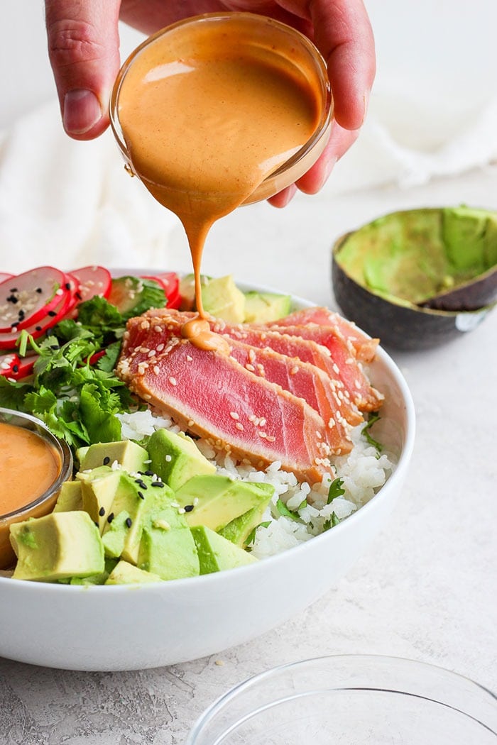 Say hello to the most delicious healthy bowl recipe you'll ever eat! This seared ahi tuna poke bowl is fresh, nutritious, and easy to make! Drizzling almond dressing onto the poke bowl