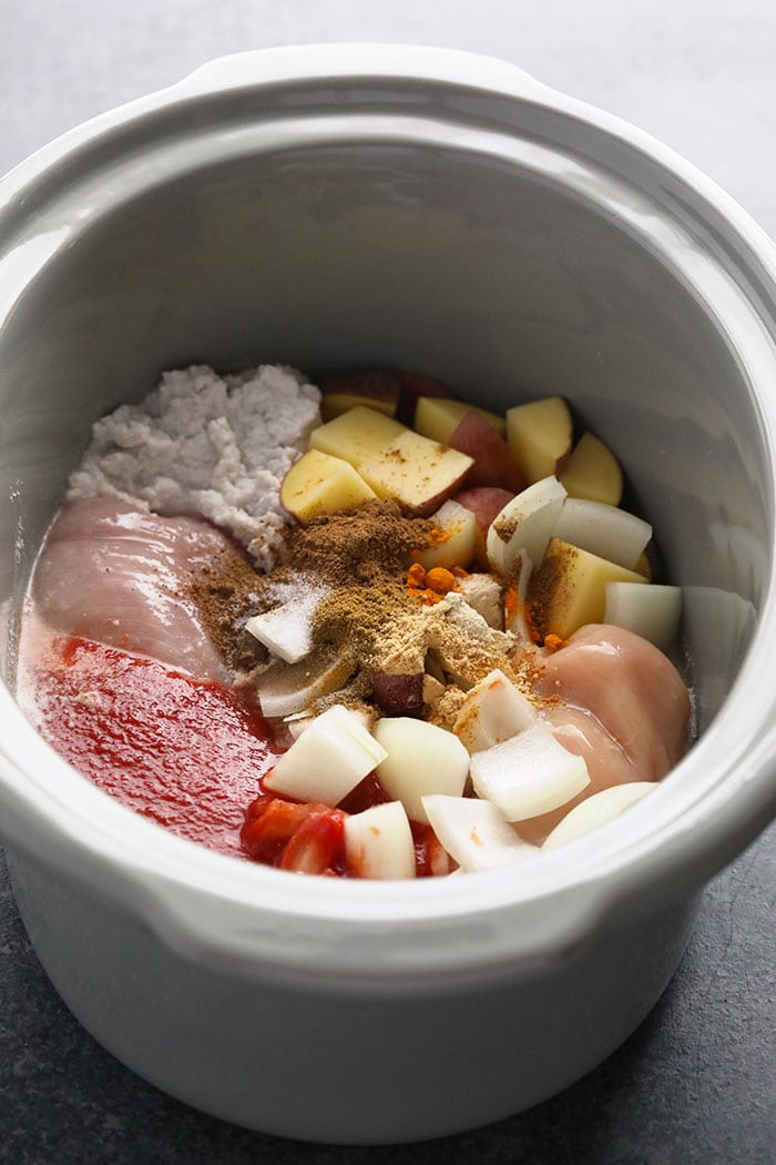 This Healthy Slow Cooker Chicken Tikka Masala is savory, hearty and made completely in the slow cooker. Prep a batch and you'll have dinner in no time, or meal prep and freeze for the perfect freezer meal at a later date. Healthy slow cooker meals have never been easier! slow cooker chicken tikka masala ingredients in a crock pot