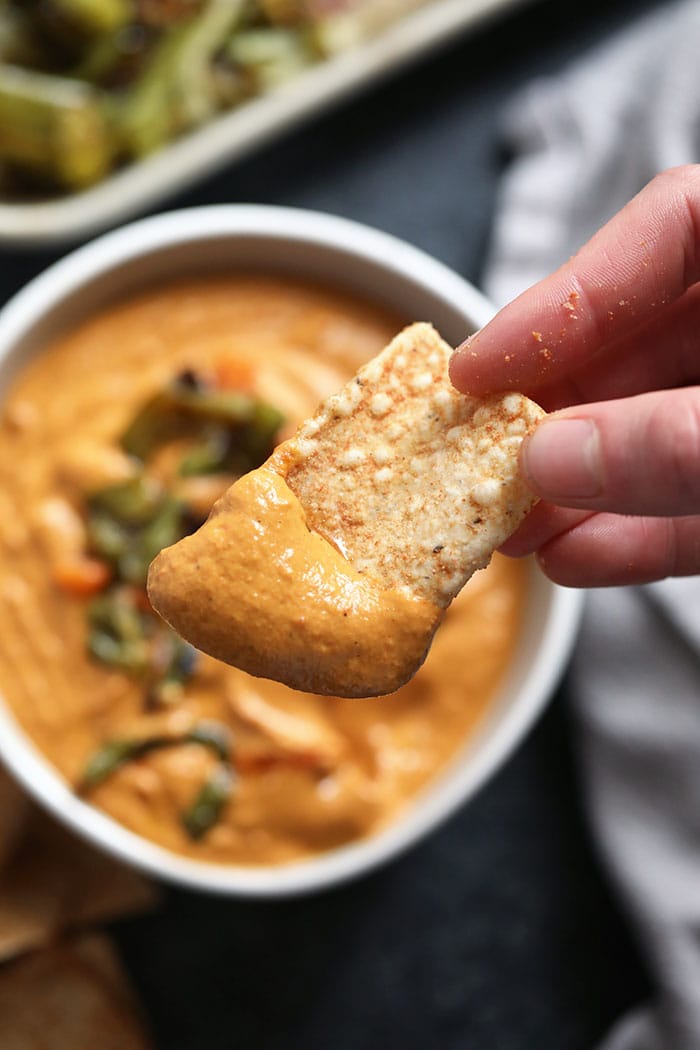 Vegan queso that tastes like the real deal. AND is packed with whole ingredients (veggies! cashews! spices!). Does it get any better?! Whip up a batch of this delicious vegan queso today. Vegan queso on a chip