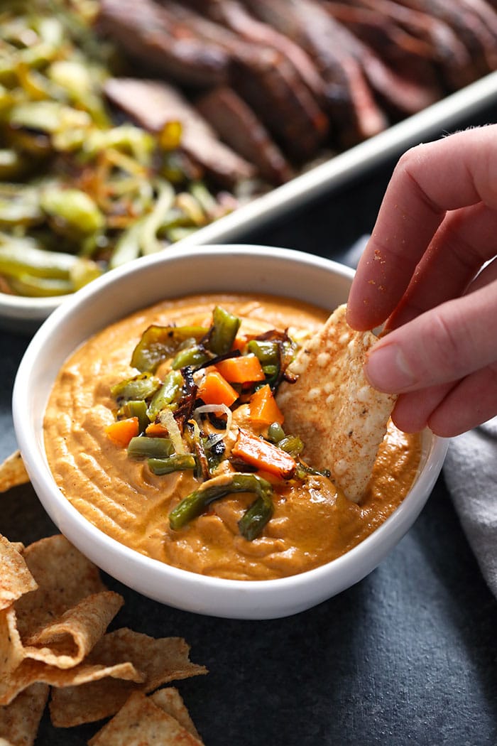 This vegan queso is absolutely addicting. It's made with soaked cashews, nutritional yeast, secret veggies, and nutritional yeast! Vegan queso in a bowl