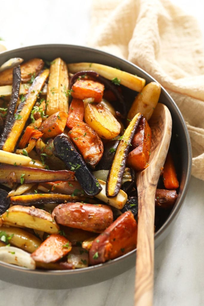 These Roasted Root Vegetables are such an easy and delicious seasonal side to serve this fall and winter! Simply cut the veggies, season, and roast for 45 min. -- that's it! Enjoy. Roasted root vegetables in a bowl ready to be served