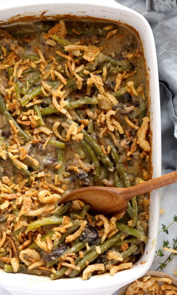 vegan green bean casserole with wooden spoon