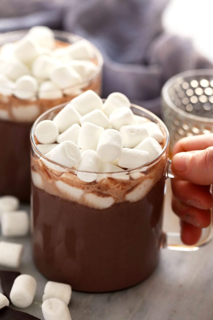 Sip on a mug of this 5-ingredient Easy Spiked Hot Chocolate topped with mini marshmallows. It truly is the perfect winter drink! spiked hot chocolate in a mug topped with mini marshmallows