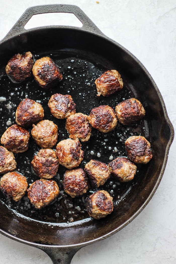The best Italian meatballs on the internet made with just a few simple ingredients! Serve these over a bed of pasta and your favorite noodle! Italian meatballs in cast iron skillet