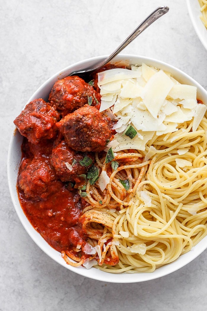 This truly is the best meatball recipe and it's simply made with ground beef, breadcrumbs, parmesan, and your favorite marinara! bowl of meatballs with spaghetti