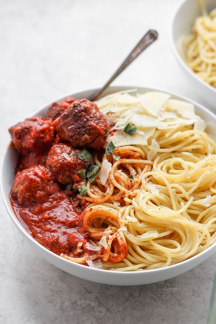 An Italian meatball recipe that the whole family will love. These meatballs are made with ground beef, Italian bread crumbs, and parmesan cheese! bowl of spaghetti and meatballs