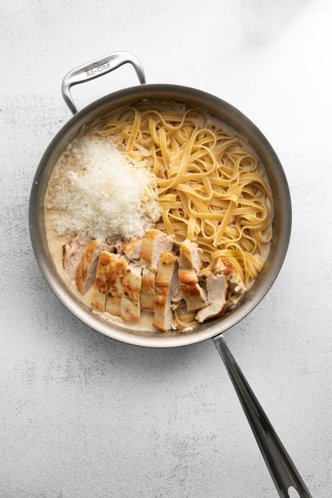 Homemade chicken Alfredo is easier to make than you think. You'll love this silky, flavorful alfredo sauce paired with pan-seared chicken and fettucini! chicken alfredo in frying pan