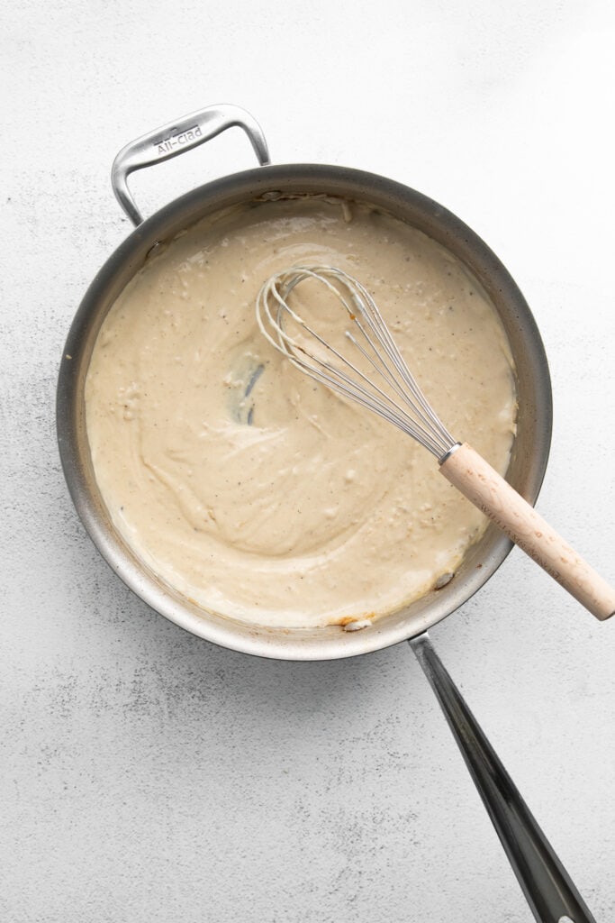 Homemade chicken Alfredo is easier to make than you think. You'll love this silky, flavorful Alfredo sauce paired with pan-seared chicken and fettuccini! roux in frying pan